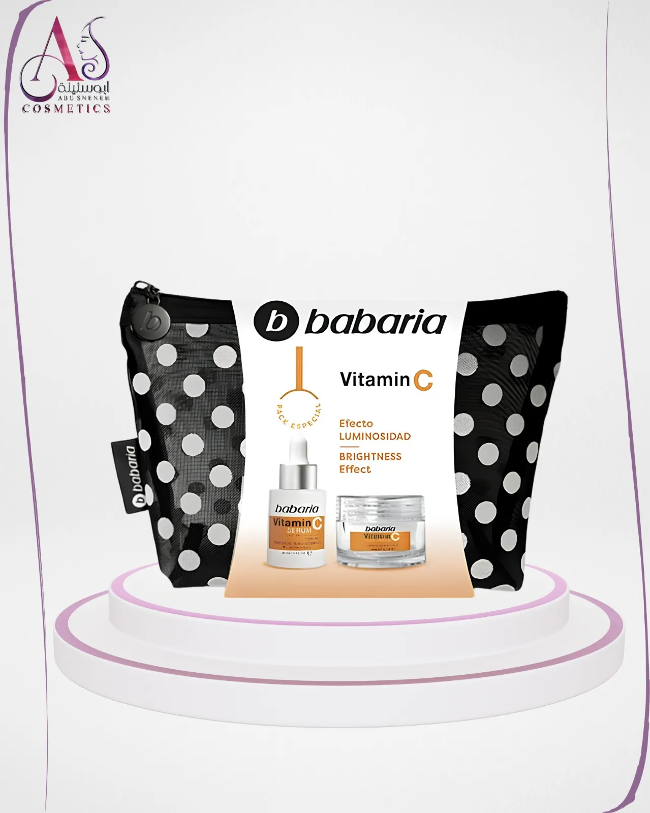 Babaria vitamin C serum and cream laid out elegantly with a stylish polka-dot cosmetic bag on a marble surface